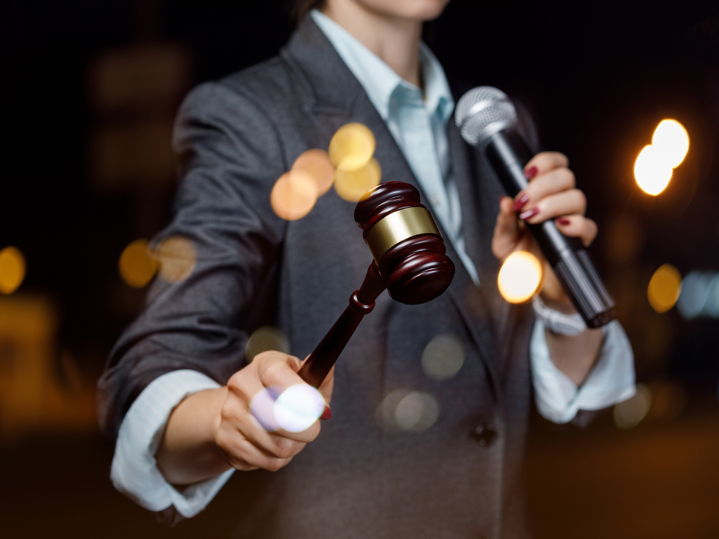 auctioneer holding gavel and mic
