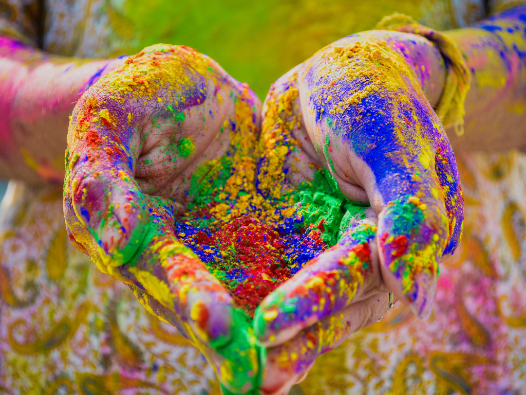 hands holding color powder