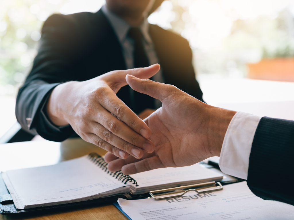 shaking hands after raising money from company